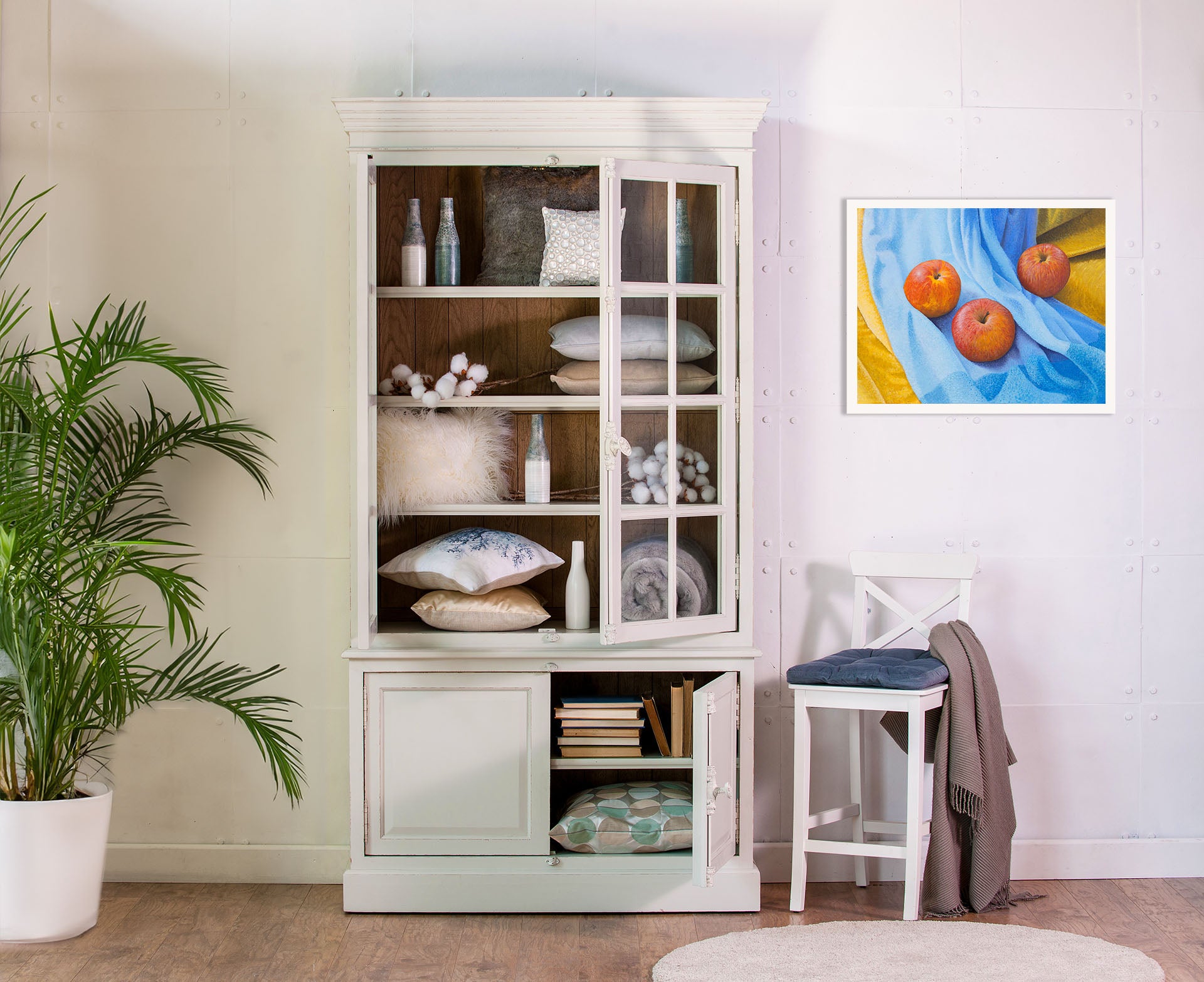 Wooden display cabinet with small white chair and wall art in background
