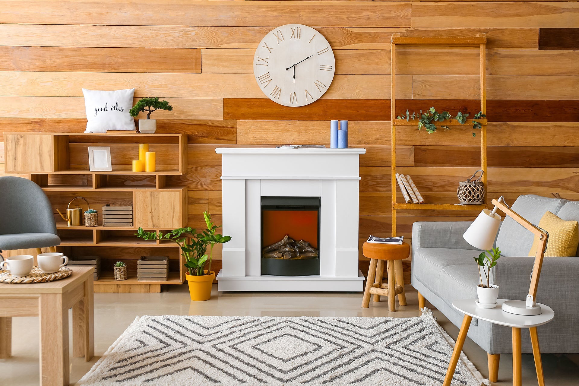 Modern living room with small sofa, wall clock and table units and wooden background